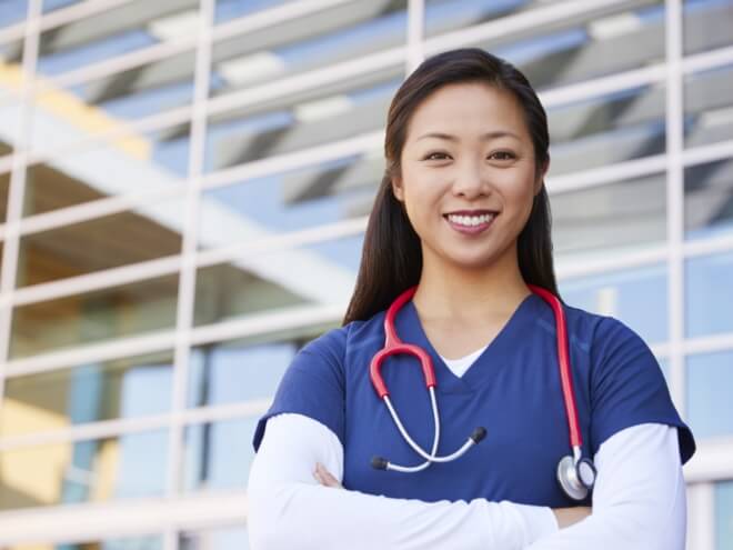 Nurse in front of building